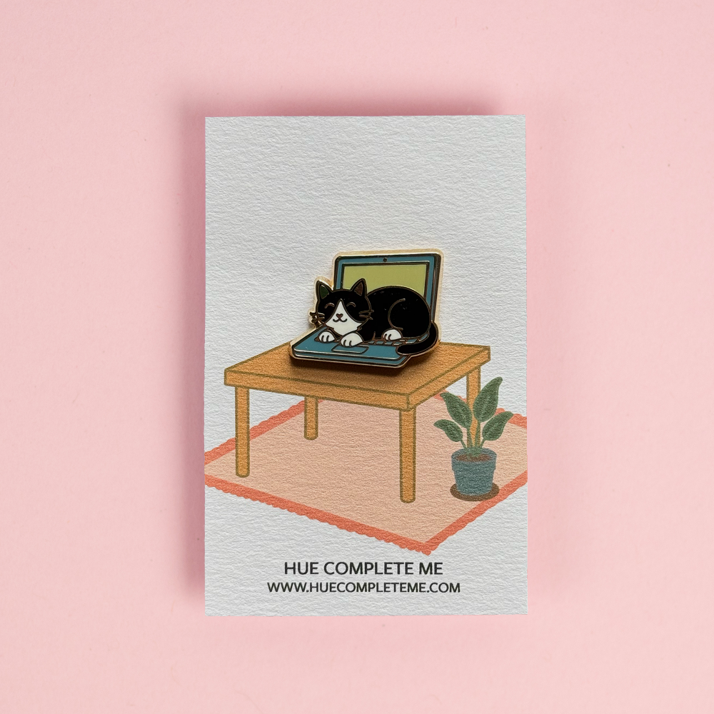 tuxedo cat on a laptop enamel pin
